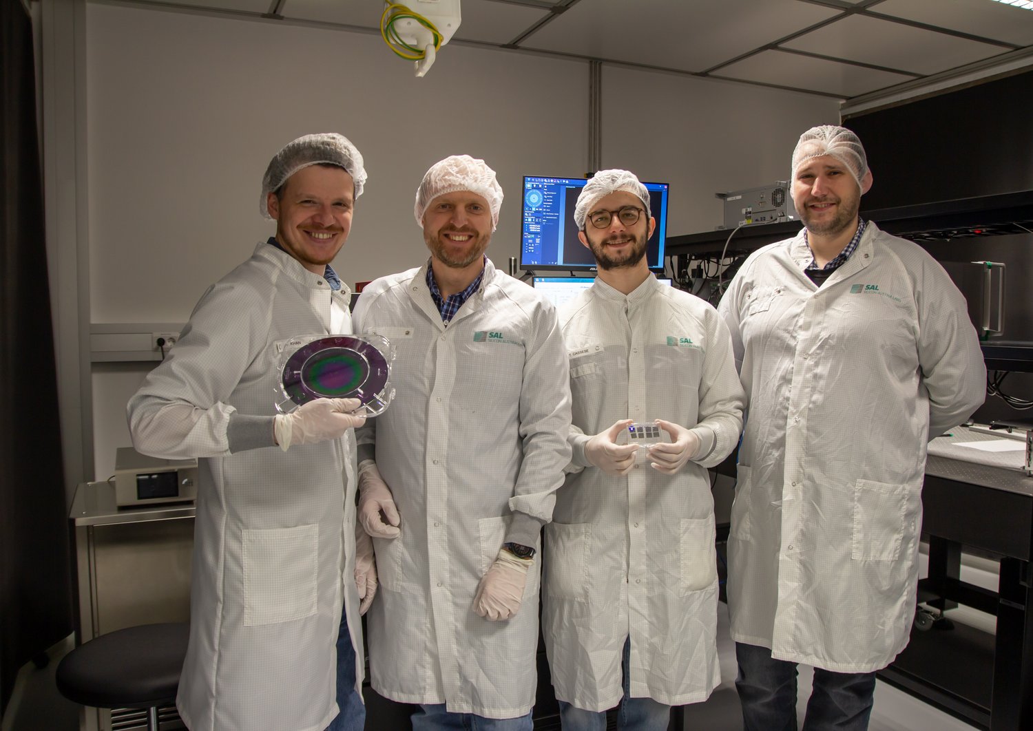 Group of researchers wearing white coats in the lab