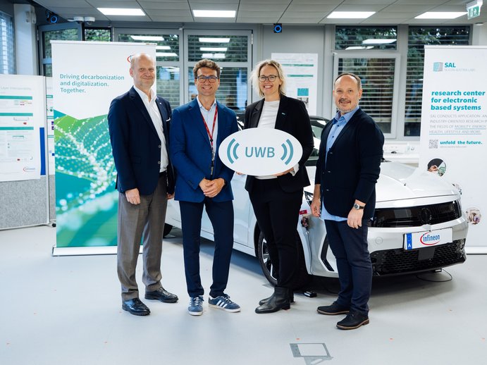 four people in the lab holding a sign