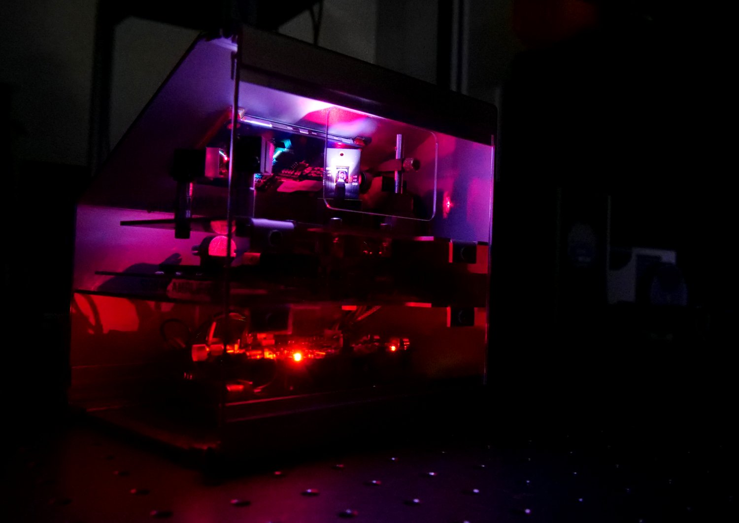 A MEMS Micromirror which is glowing red and purple