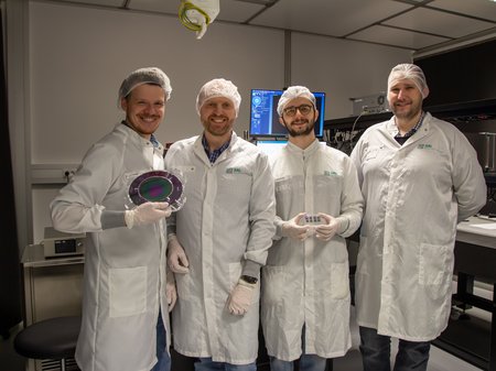 Group of researchers wearing white coats in the lab