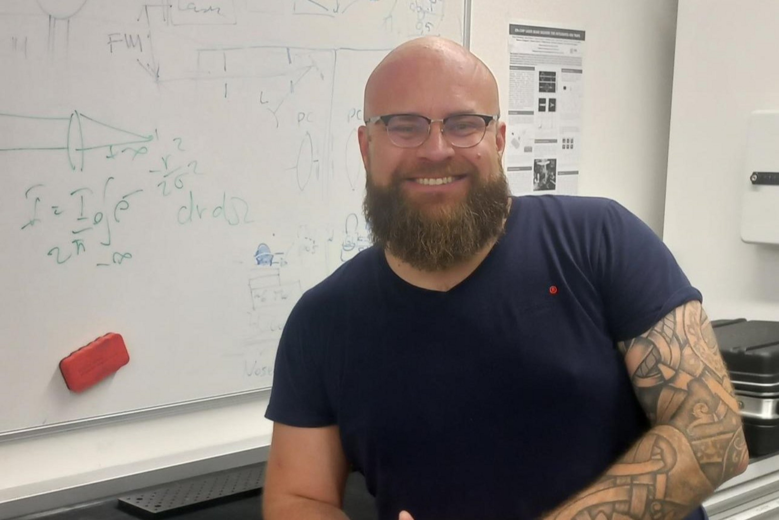 Matteo Montagnese in the office, standing in front of a blackboard with formulas written on it