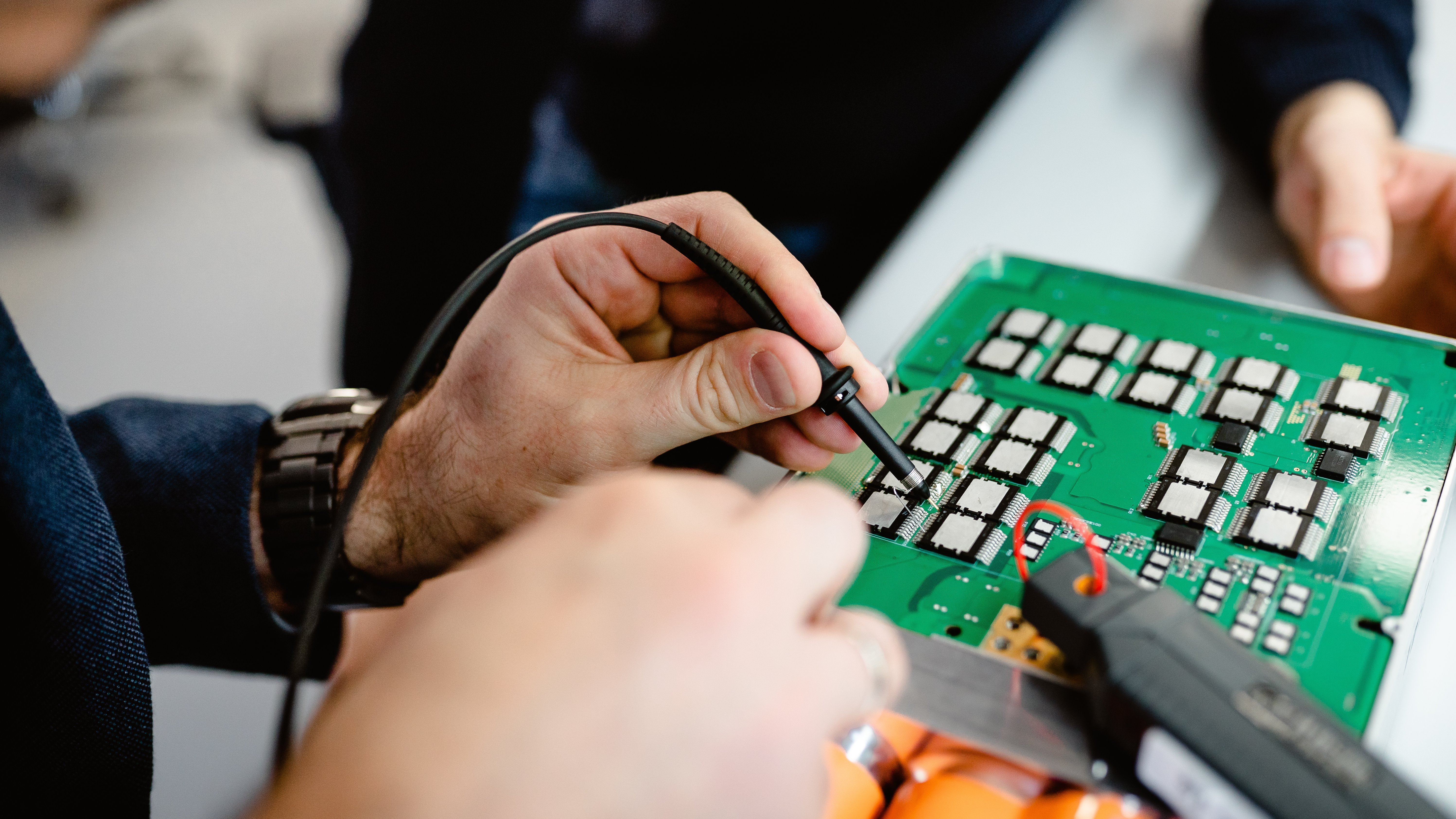 close-up of someone working on a printed circuit board