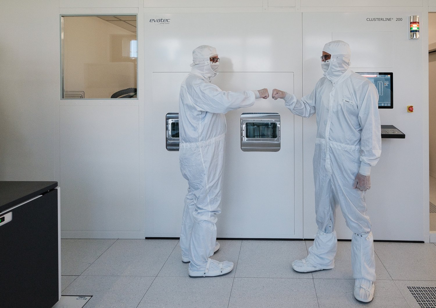 Two researchers standing in a clean room