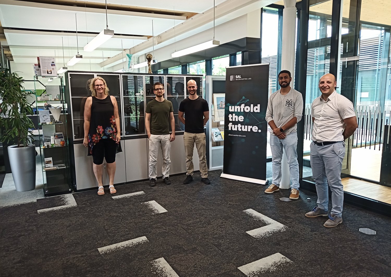 Five scientists which are standing next to each other