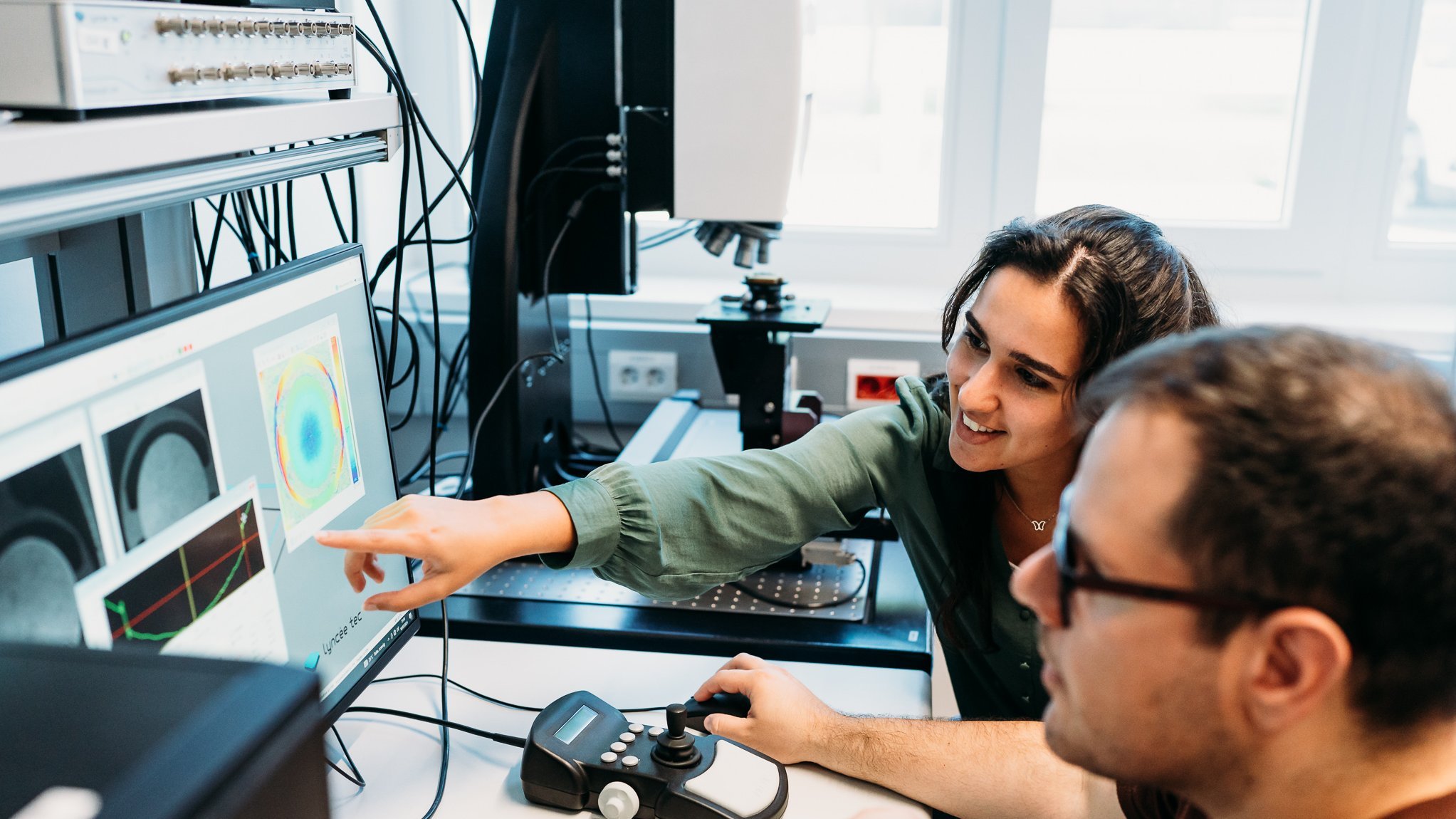 two researchers in a lab, laughing