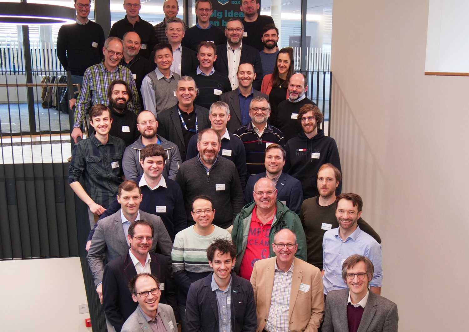On a staircase stands the research team of the Tiny Power Box