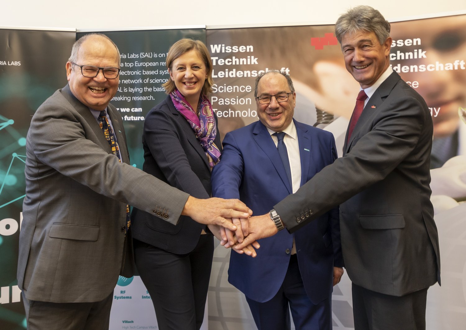 Four People who put their hands together in the middle