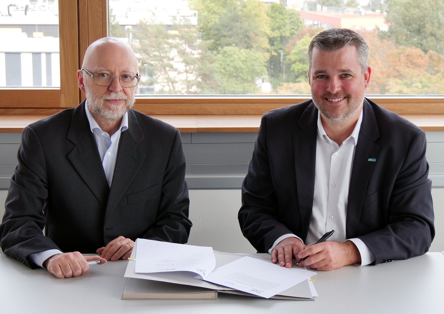 Alessandro Cimatti and Gerald Murauer smile into the camera 