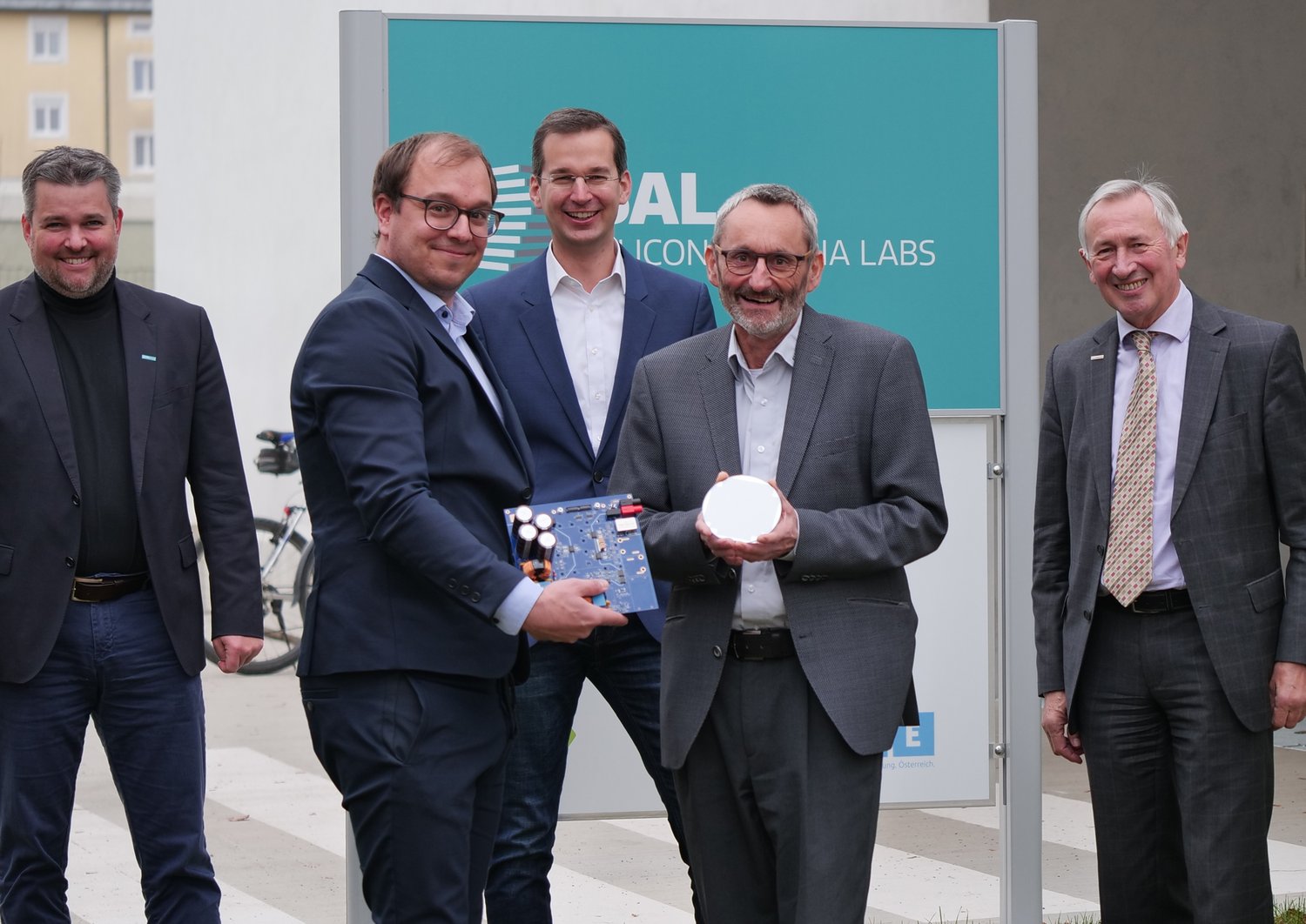 Rudolf Krall, Gerald Murauer, Hubert Berger, Karl Peter Pfeiffer and Martin Payer standing in front of the SAL building