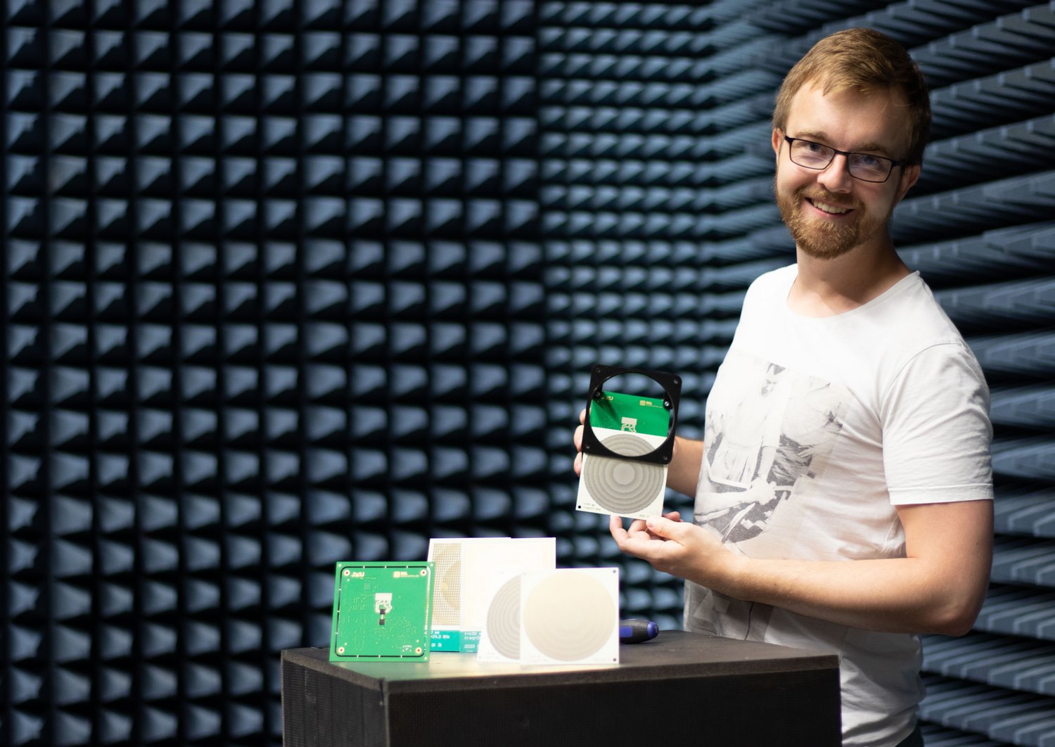 researcher holds the new lenses/reflectors into the camera